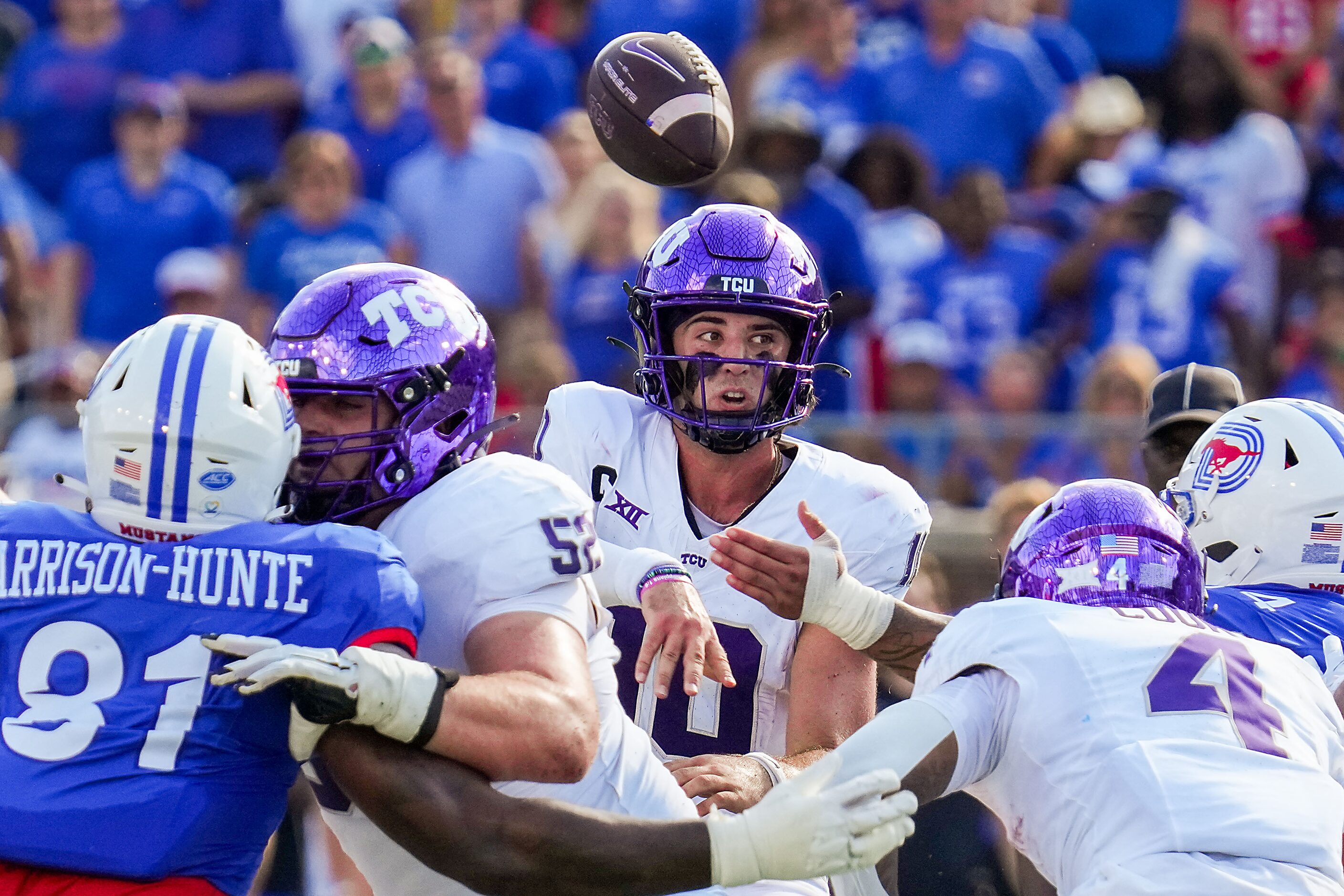 TCU quarterback Josh Hoover (10) throws a pass under pressure from SMU defensive lineman...