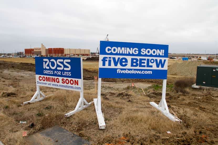 Signs for a new Ross Dress For Less and Five Below that will be part of a large shopping...