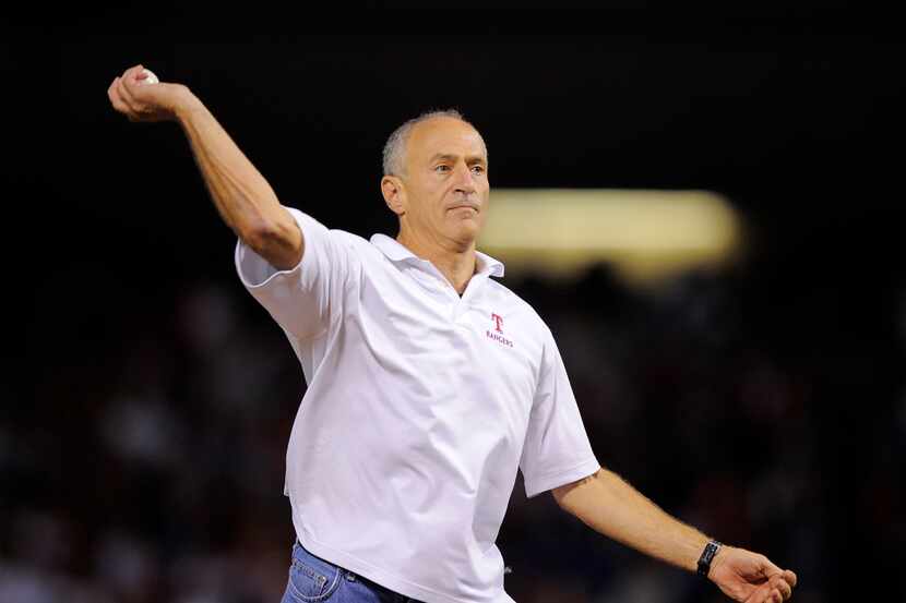 Eric Nadel throws the ceremonial first pitch before Game 1 of baseball's American League...