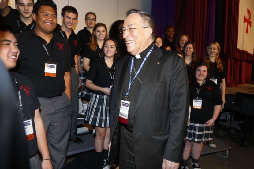 Cardinal Óscar Andrés Rodríguez Maradiaga greets the Bishop Lynch High School Choir after...