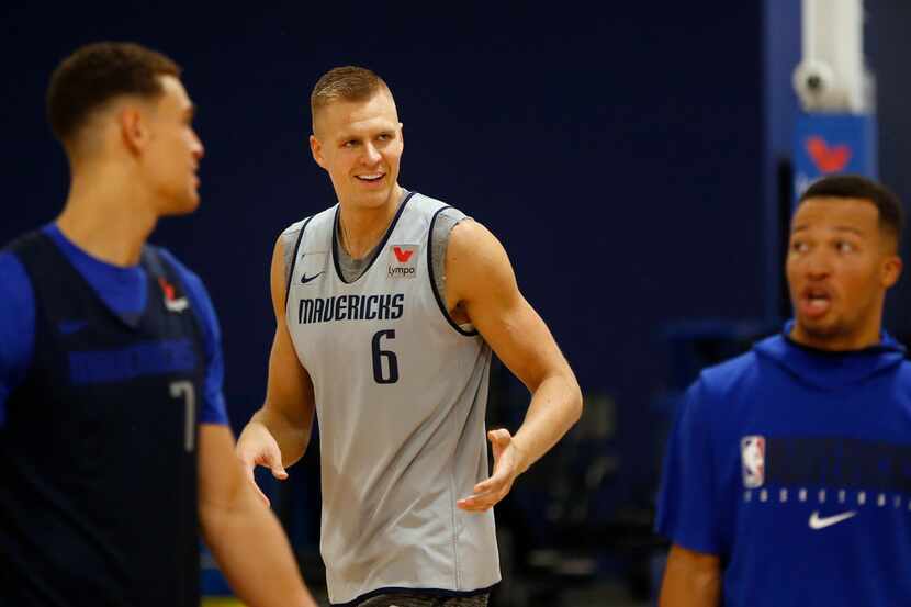 Dallas Mavericks forward Kristaps Porzingis (6) makes his rounds shooting three pointers as...