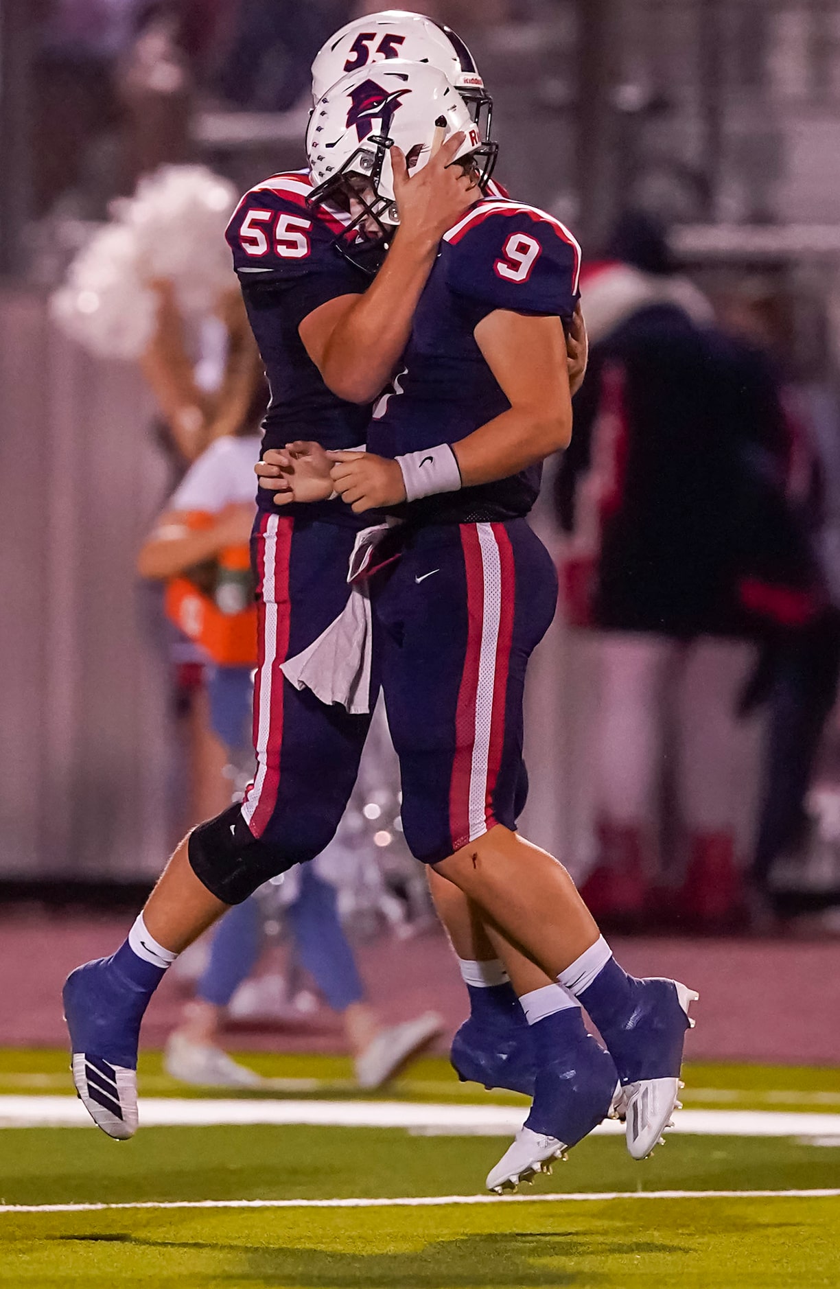 Aubrey quarterback Jaxon Holder (9) celebrates with offensive lineman Lane Bartel (55) after...