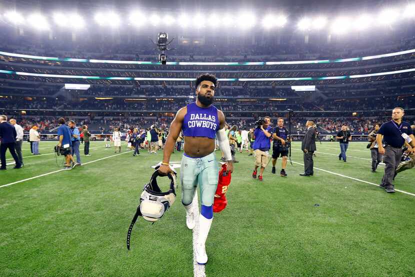 Dallas Cowboys running back Ezekiel Elliott (21) heads for the locker room following their...