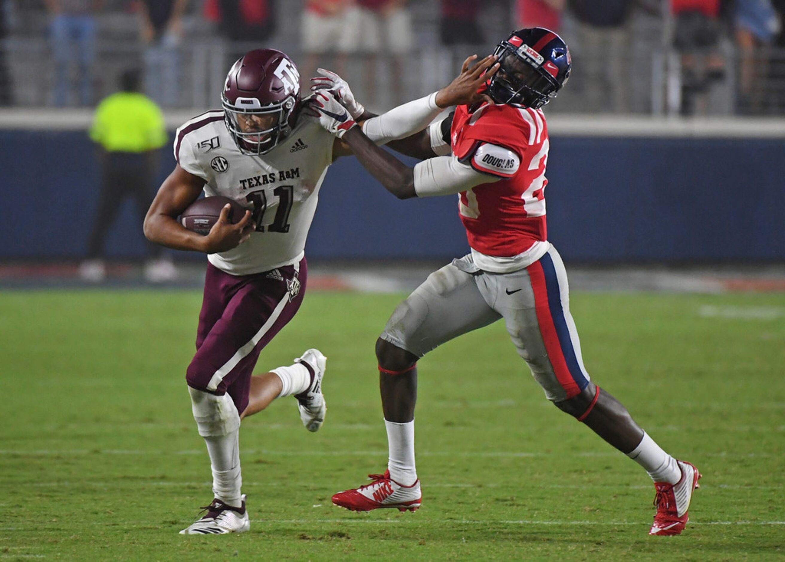 Texas A&M quarterback Kellen Mond (11) carries past Mississippi defensive back Keidron Smith...