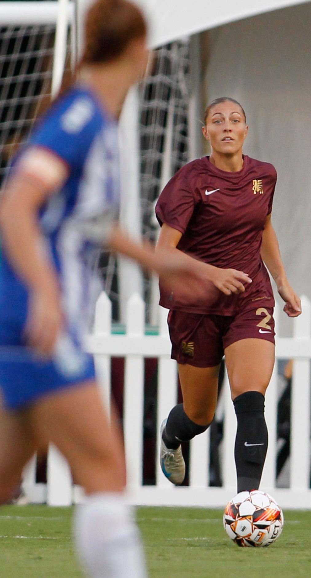 Dallas Trinity FC's Hannah Davison (2), right, brings the ball toward the pitch during first...