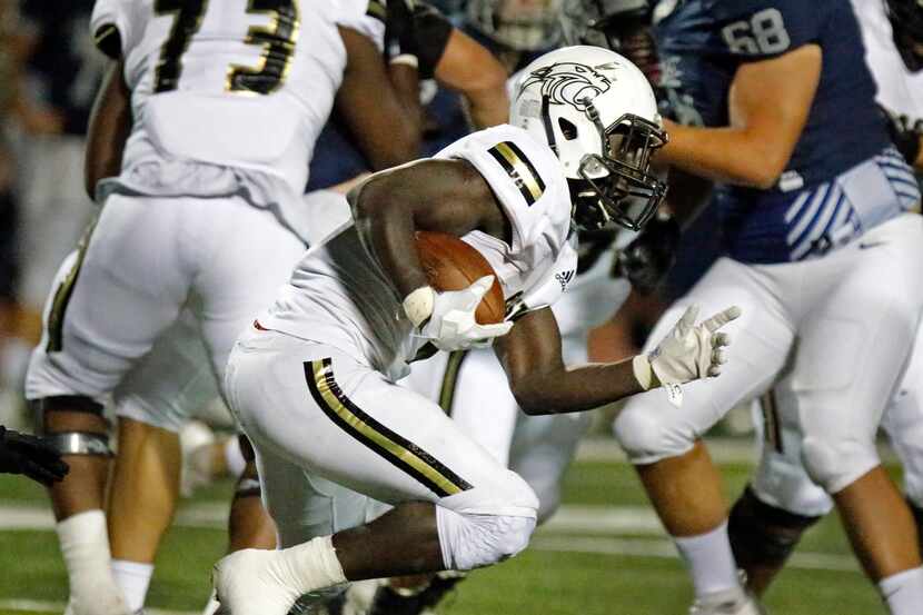 Plano East running back Ismail Mahdi looks for running room against Flower Mound on October...