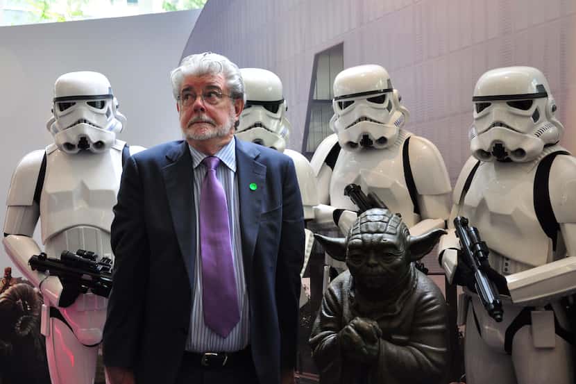Filmmaking legend George Lucas (front L) of Disney's Lucasfilms poses with Stormtroopers...