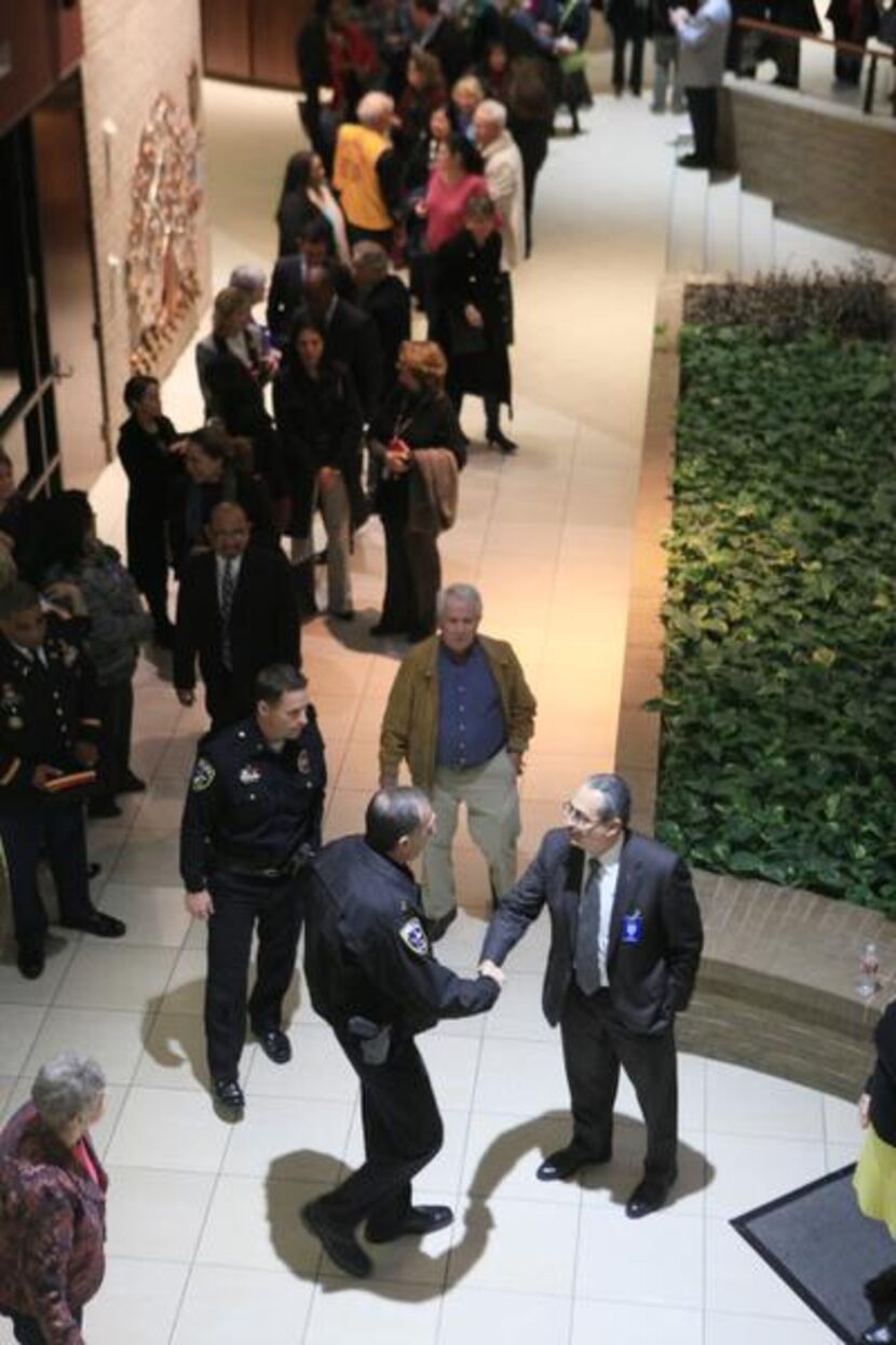 Irving chief of police Larry Boyd (left) shakes the hand of new Irving ISD superintendent...