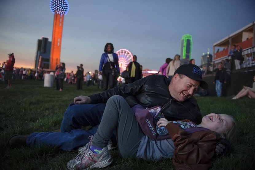 Robert Roye plays with his daughter Lucy, 10, the youngest of six, as they wait for the...