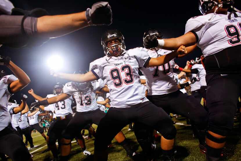 Euless Trinity football players psych themselves up before kickoff against Southlake Carroll...
