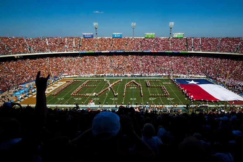 Texas Longhorns fans cheer as the band performs before the AT&T Red River Showdown college...