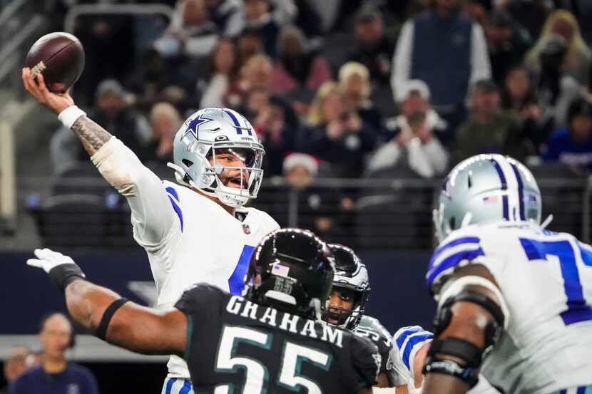 Dallas Cowboys quarterback Dak Prescott (4) throws a pass under pressure from Philadelphia...