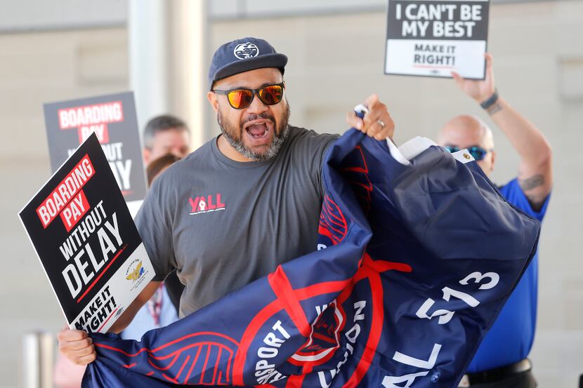 Tevita Uhatafe with the Transport Workers Union of America, chants in solidarity as the...
