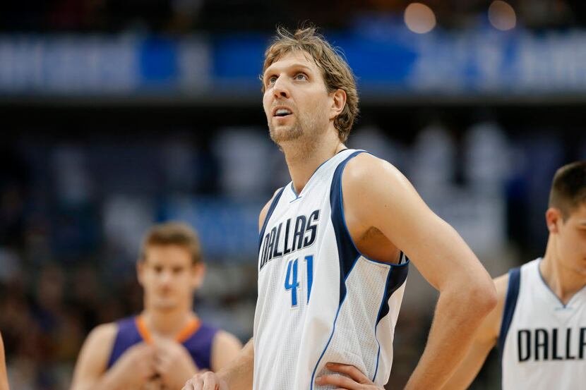 Dallas Mavericks' Dirk Nowitzki (41) of Germany watches a replay on the video screen in the...