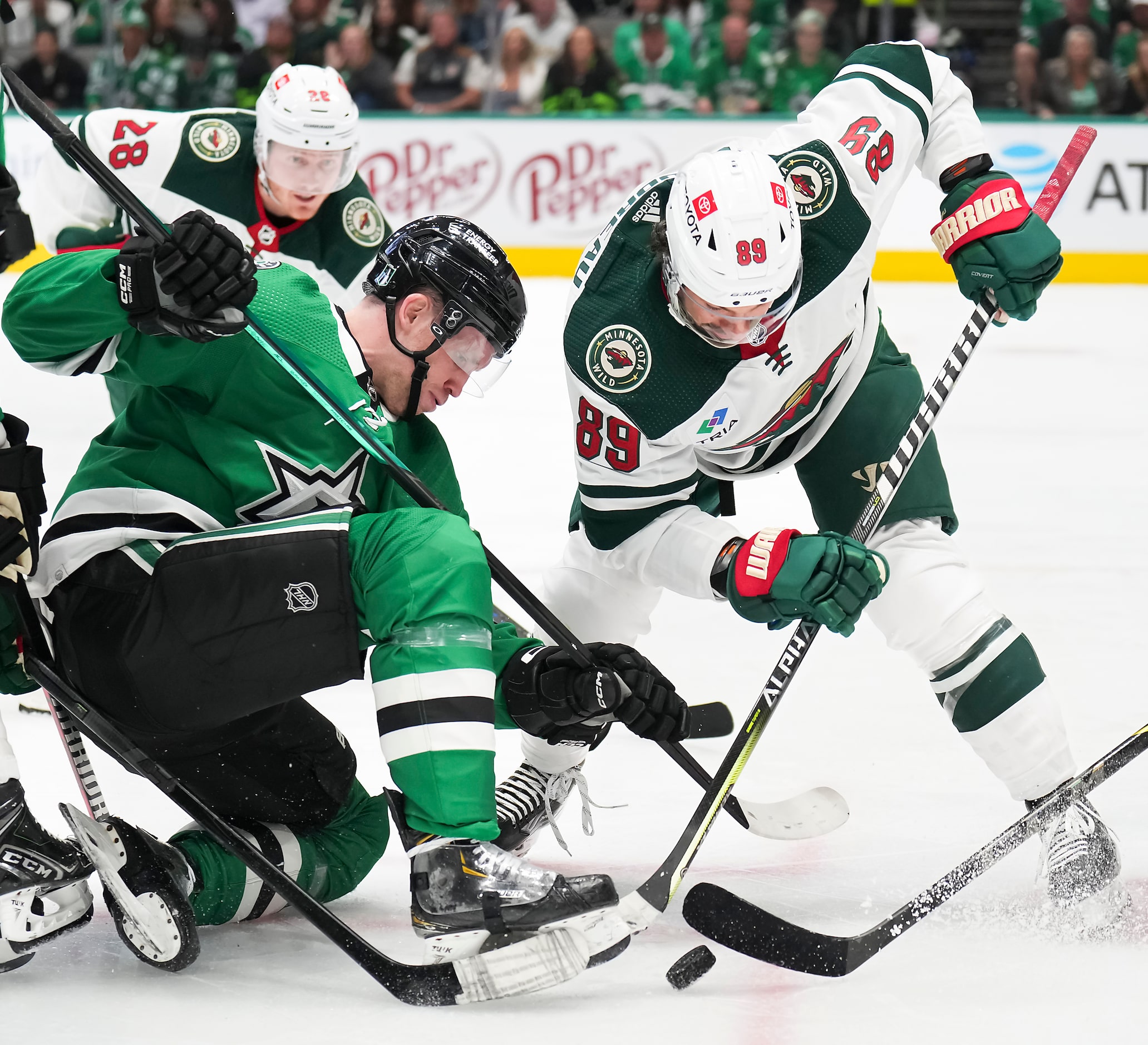 Dallas Stars center Radek Faksa (12) fights for the puck against Minnesota Wild center...