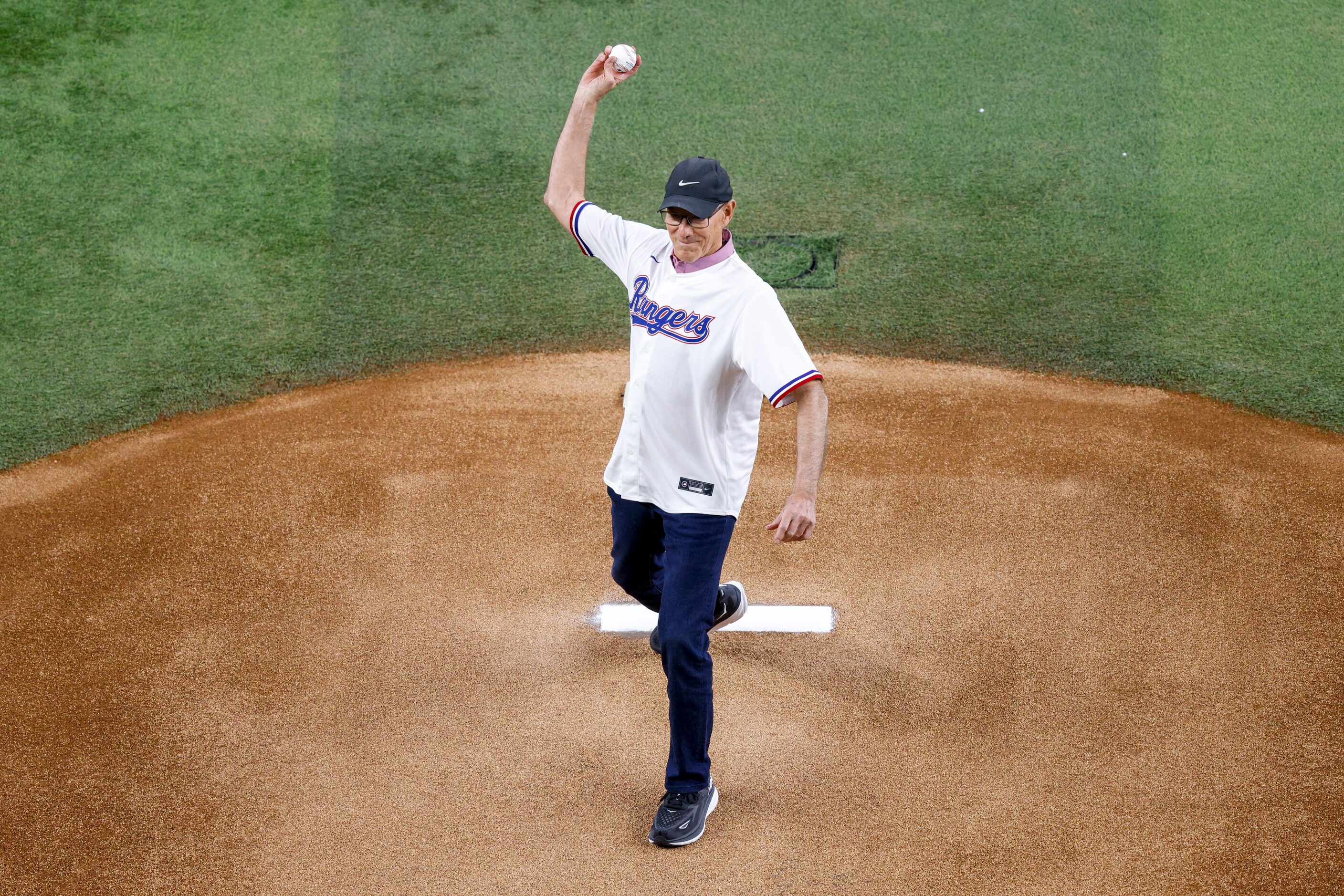 Former Texas Rangers player Tom Grieve throws the ceremonial first pitch before Game 5 of...