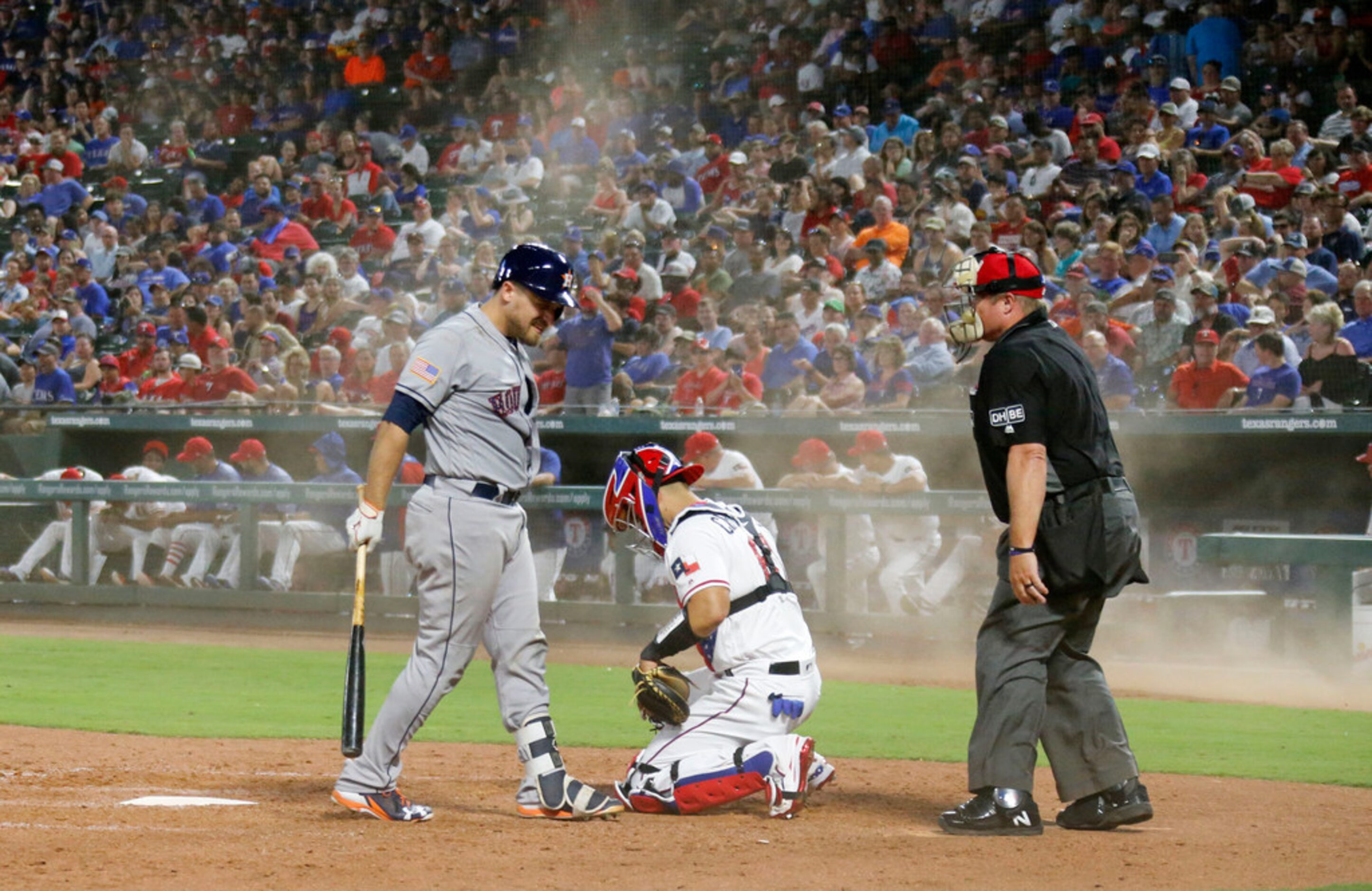 Astros catcher Tim Federowicz and Rangers cacher Robinson Chirinos take a moment to let the...