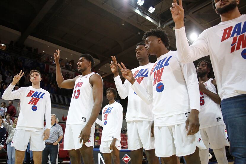 SMU players pause for the playing of the school song following their 68-58 victory over...