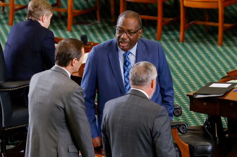 State Sen. Royce West (facing), D-Dallas, chatted in the Senate chamber at the Capitol in...