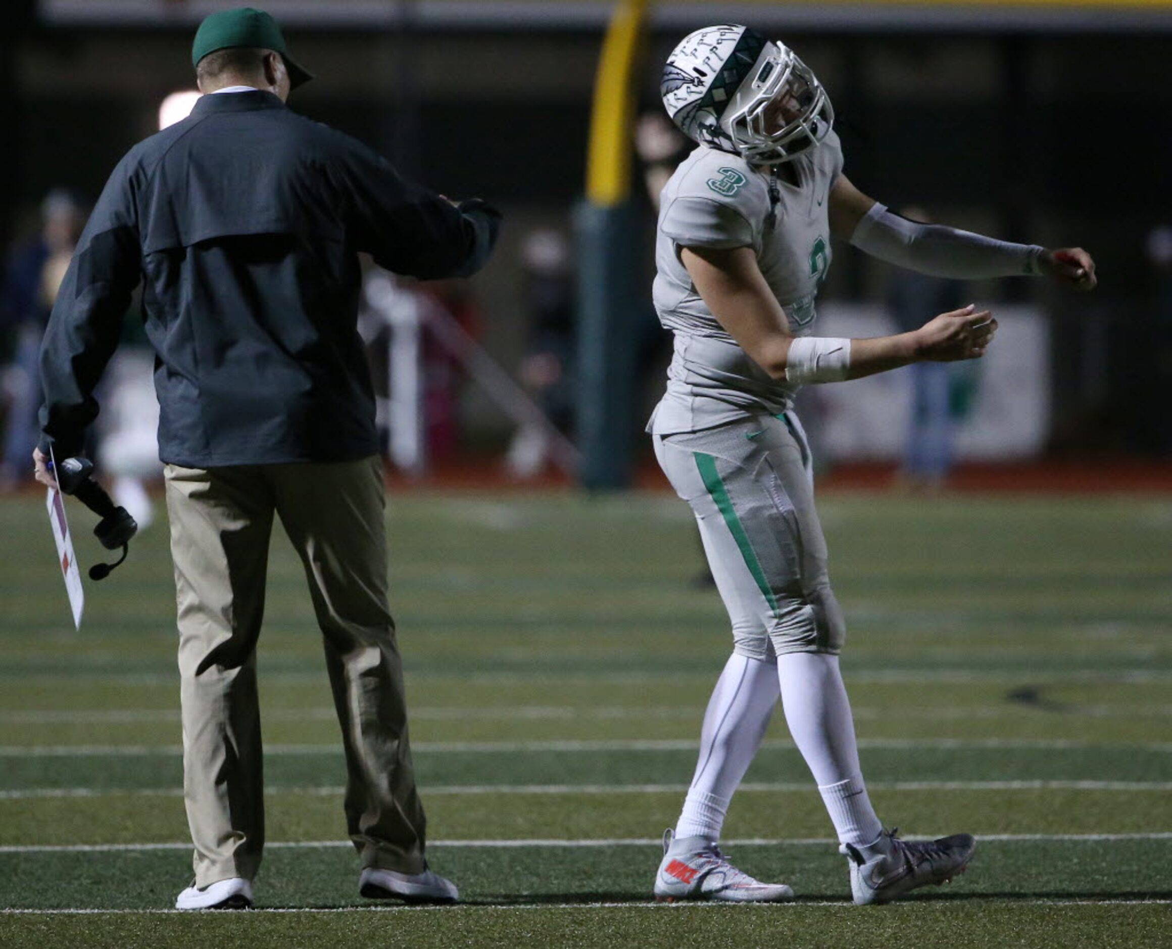 Waxahachie quarterback Jordan Kitna (3) pulls away from his father and head coach Jon Kitna...