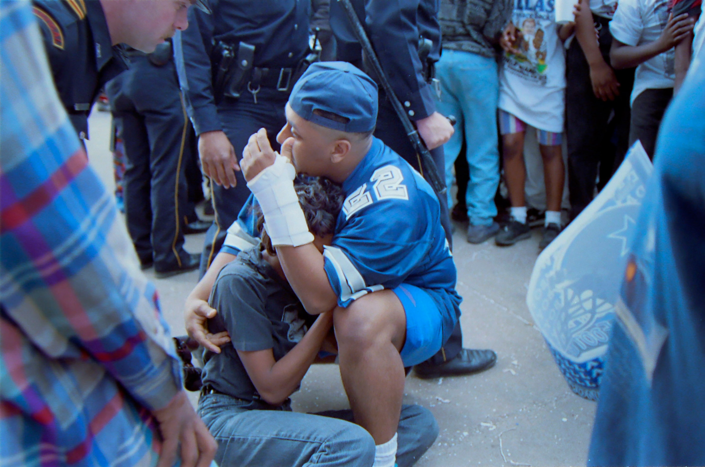 Dallas Cowboys fans are protected by Dallas police after violence erupted following the...