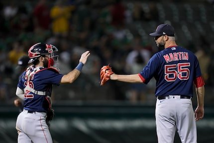 Boston Red Sox catcher Connor Wong, left, and pitcher Chris Martin celebrate after the...