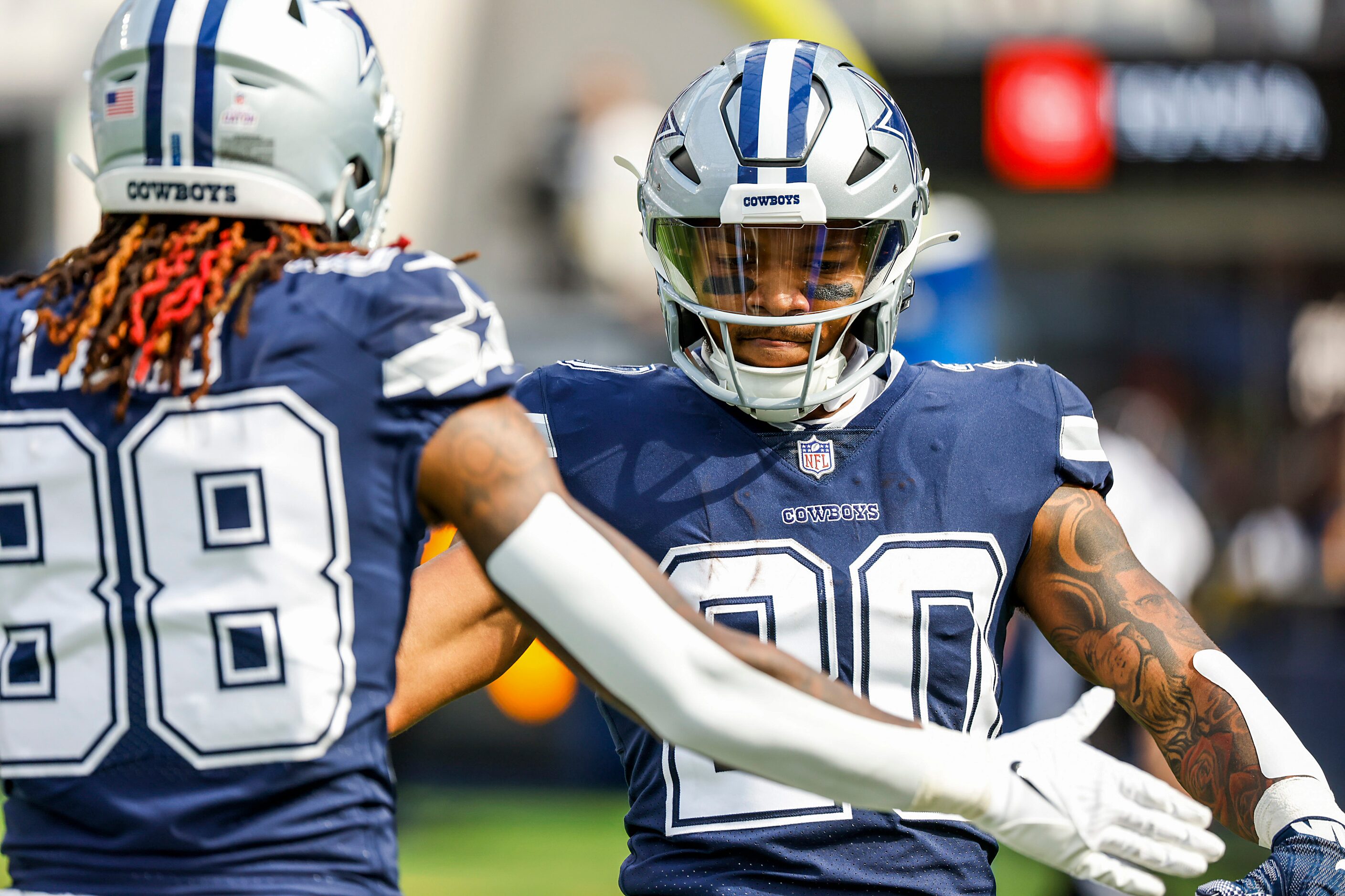 Dallas Cowboys running back Tony Pollard (20) celebrates with wide receiver CeeDee Lamb (88)...