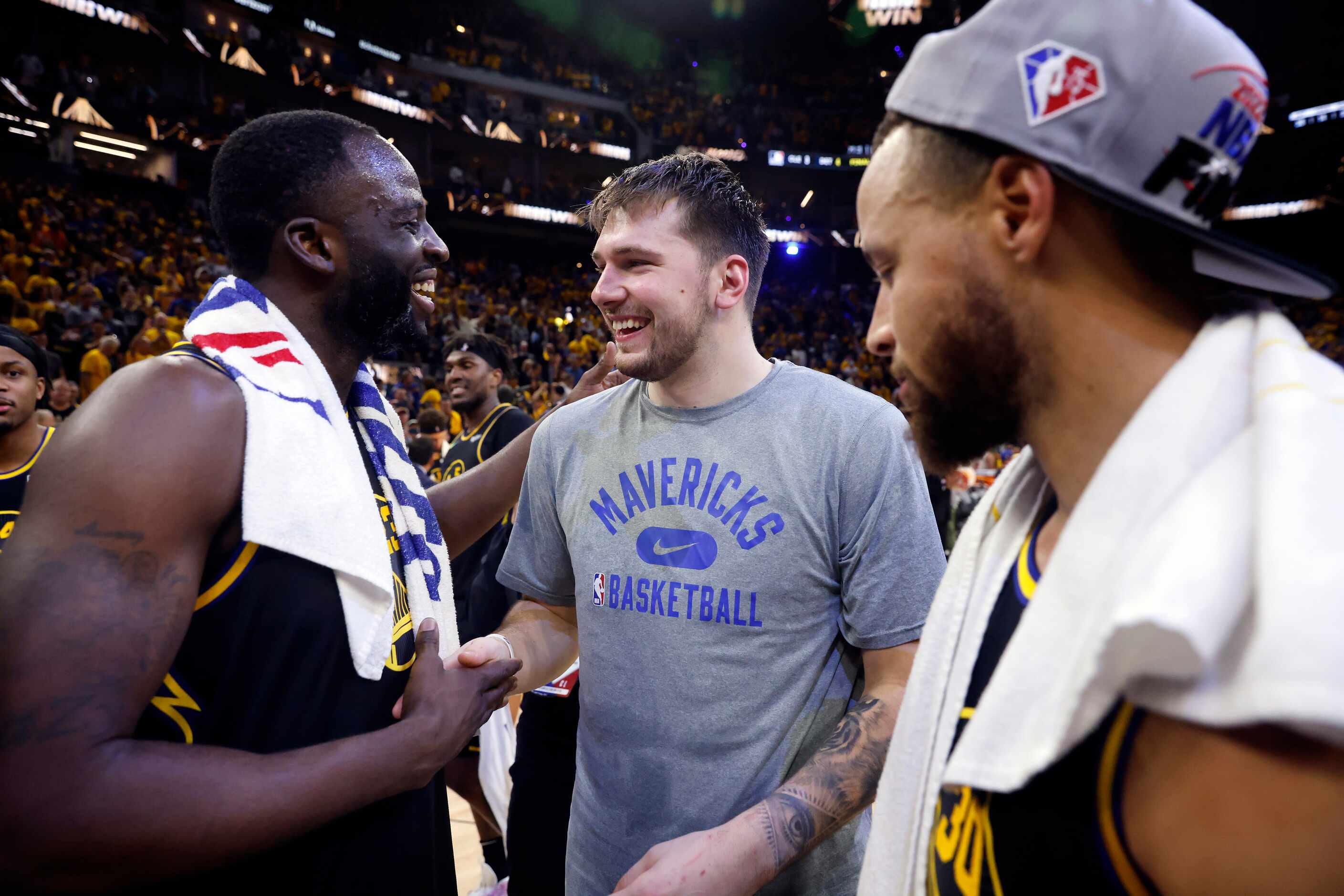 Dallas Mavericks guard Luka Doncic (center) congratulates Golden State Warriors forward...