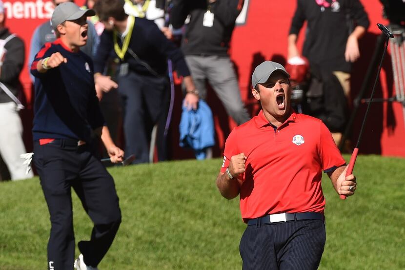 Team USA Patrick Reed (R) reacts with teammate Jordan Spieth after winning their match...