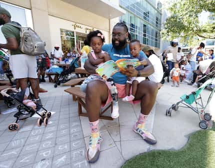 3-year-old Leila Anderson (left) Damani Anderson, and 1-year-old Camara Anderson read during...