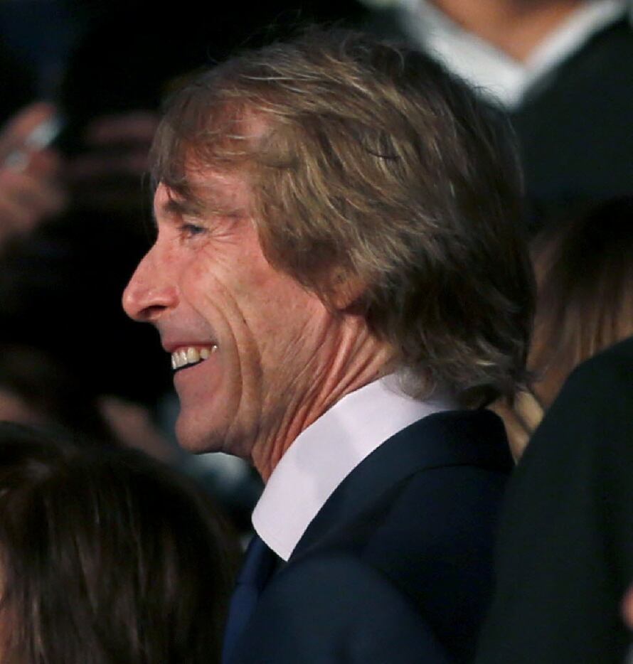 Director Michael Bay smiles on the red carpet at the world premiere of 13 Hours: The Secret...