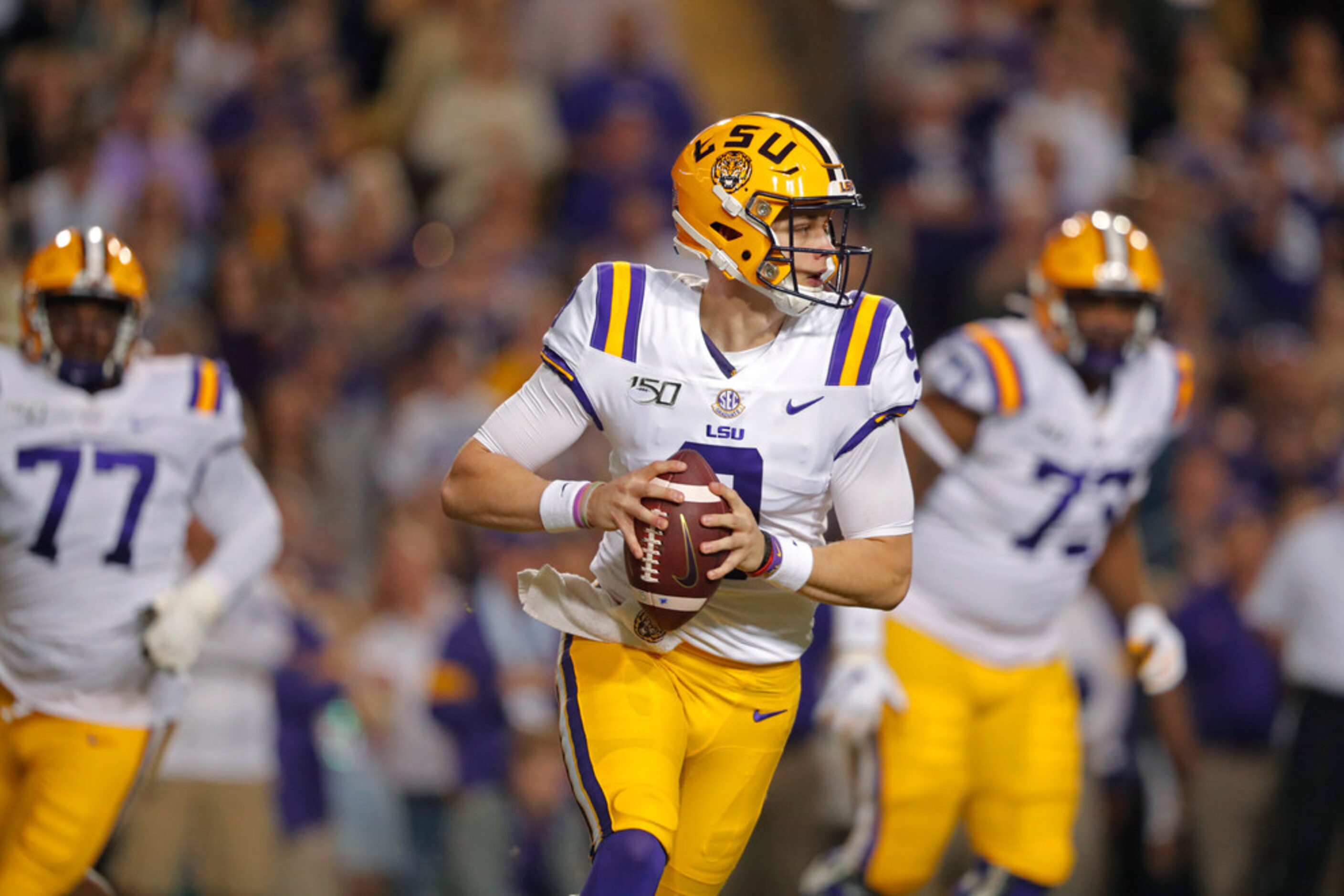 LSU quarterback Joe Burrow (9) scrambles in the first half of an NCAA college football game...