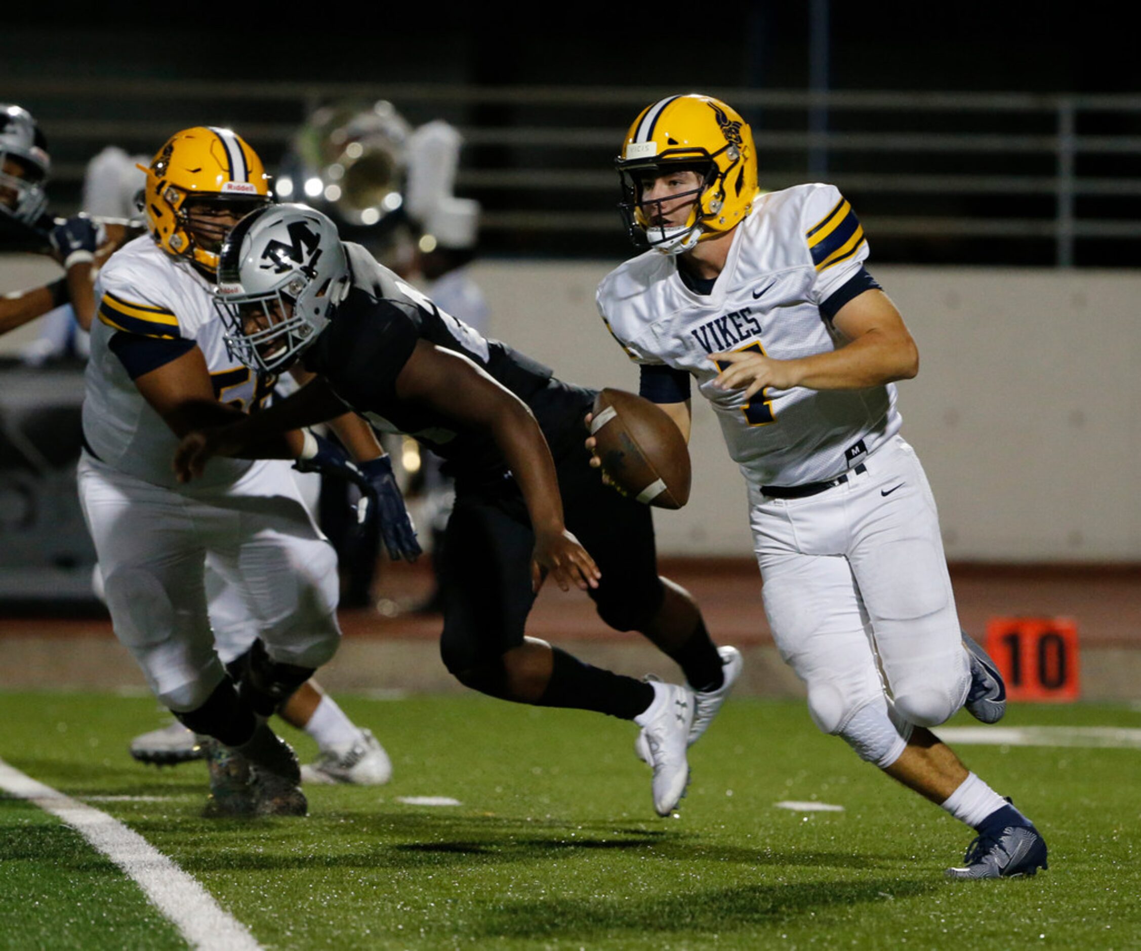 Arlington Lamar quarterback Jack Dawson (7)  scramble for yardage against Arlington Martin...