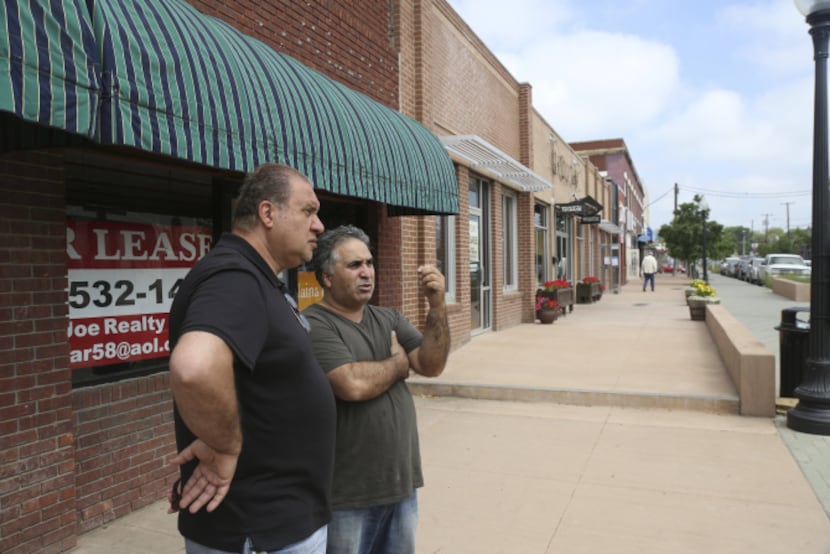 Joseph Sukkar (left), a landlord on Lower Greenville, talks with Budget Buddies contractor...