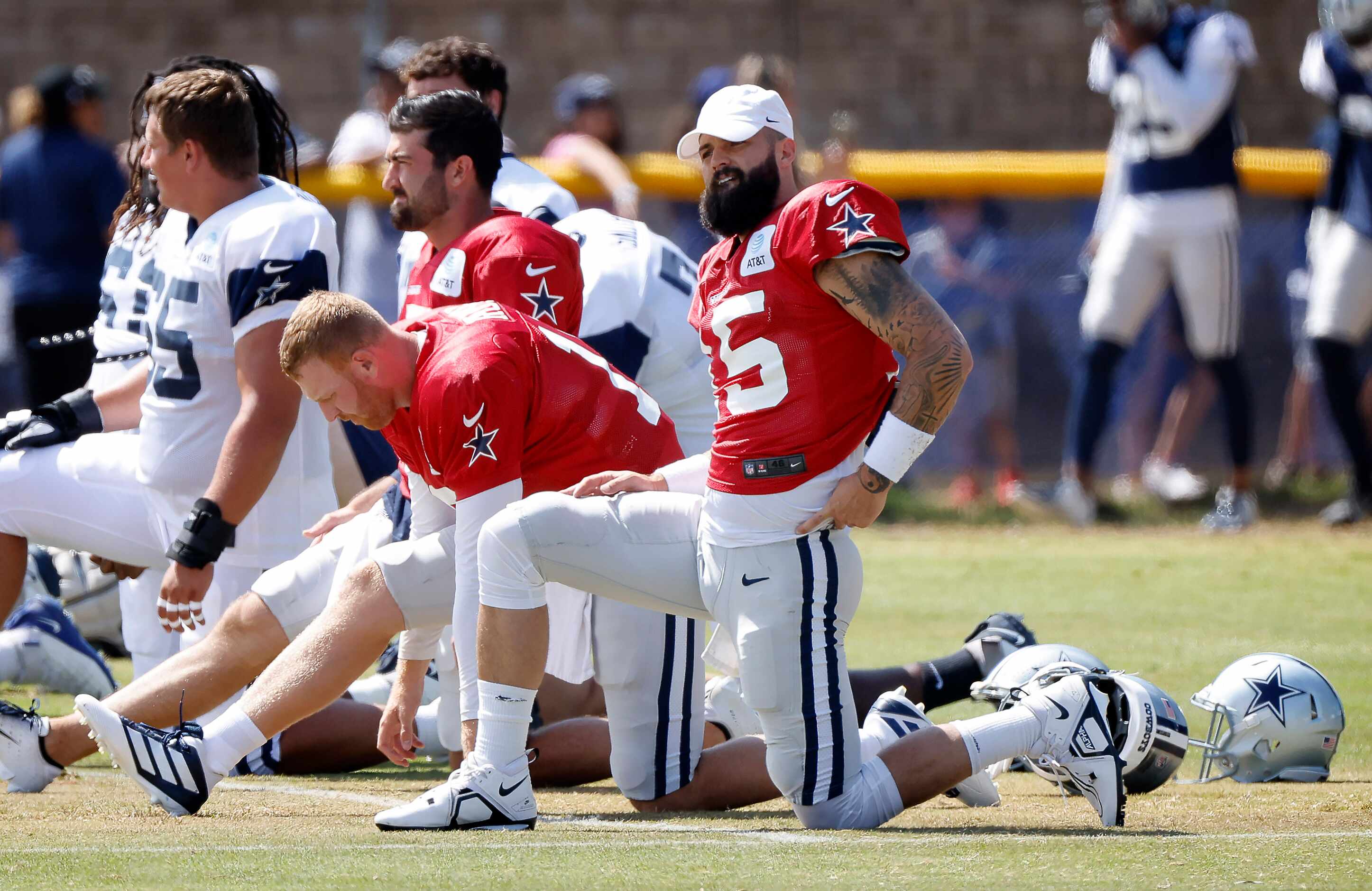 Dallas Cowboys backup quarterbacks (from right) Will Grier (15), Cooper Rush (10) and Ben...