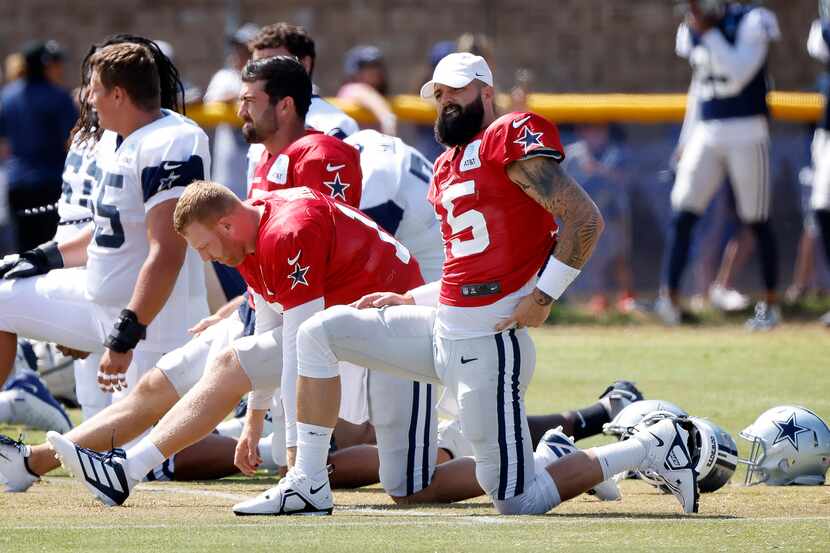 Dallas Cowboys backup quarterbacks (from right) Will Grier (15), Cooper Rush (10) and Ben...