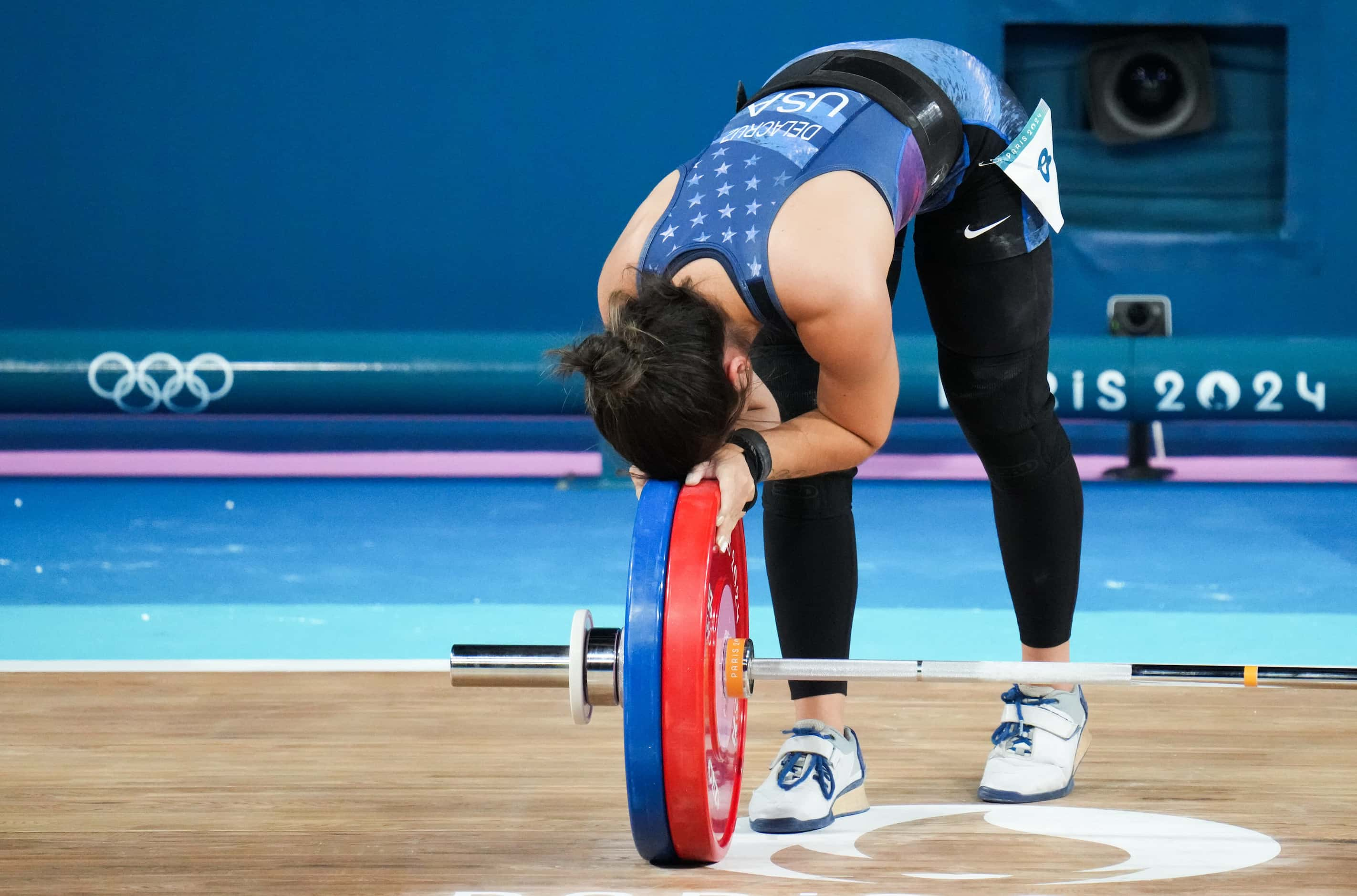 Jourdan Delacruz of the United States reacts after lifting 111kg in the clean and jerk...