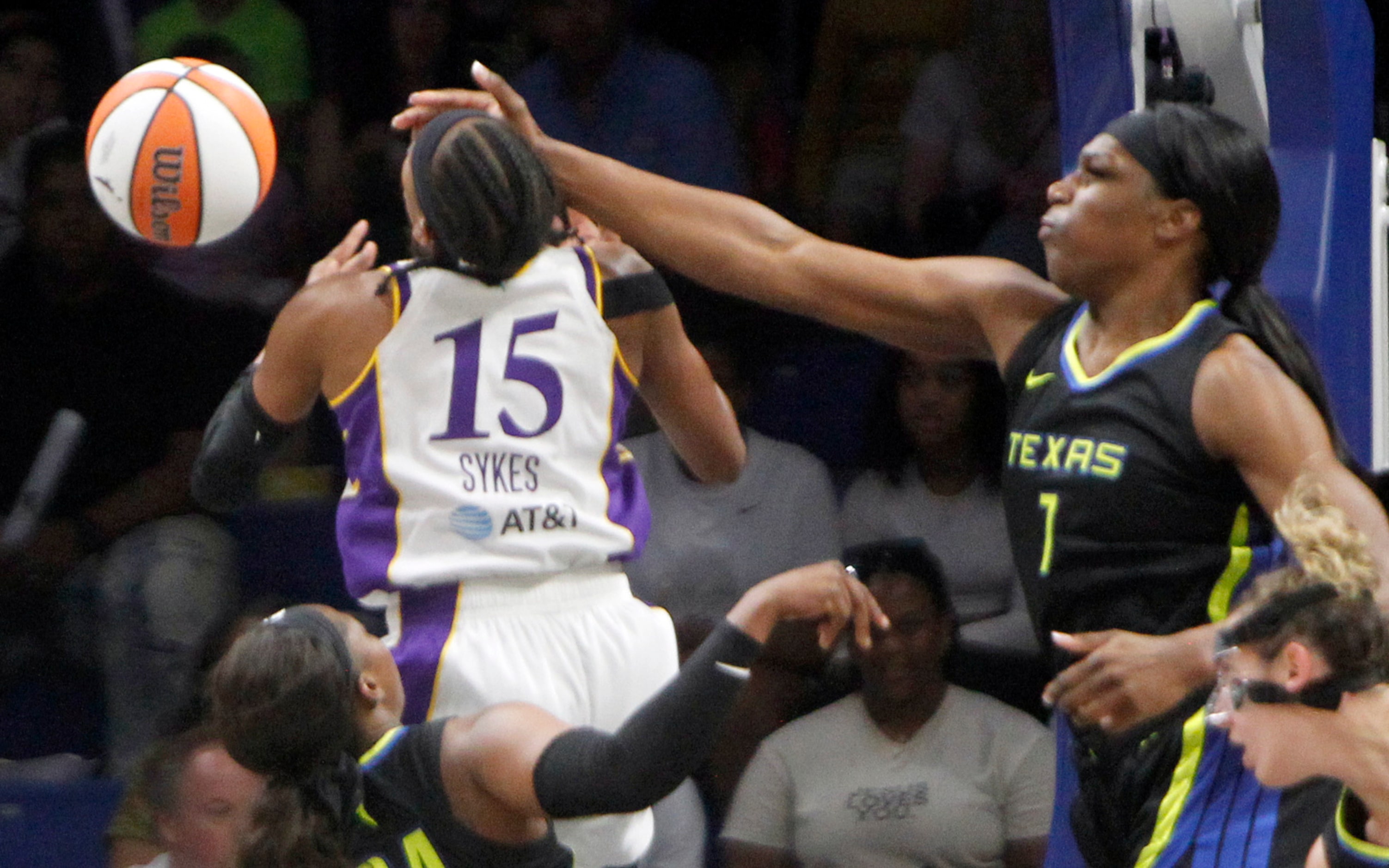 Dallas Wings center Teaira McCowan (1) extends a hand defensively to impede the offensive...