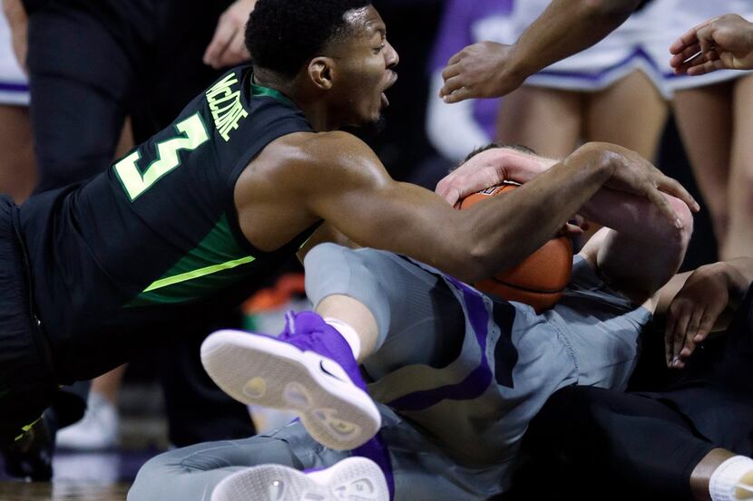 Baylor guard King McClure (3) dives for the ball held by Kansas State forward Dean Wade,...