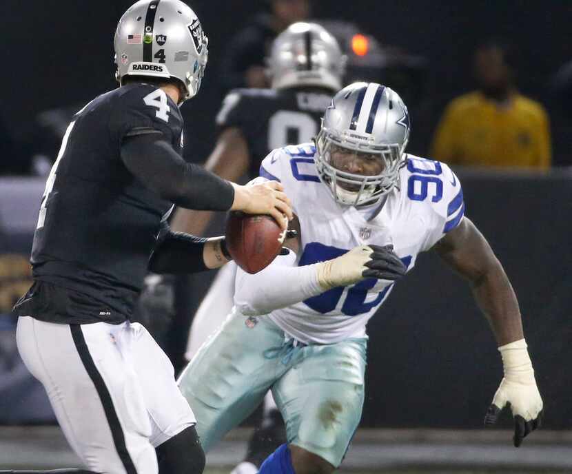 Dallas Cowboys defensive end Demarcus Lawrence (90) rushes Oakland Raiders quarterback Derek...