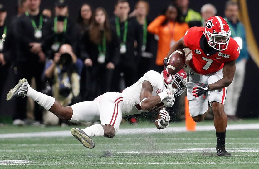 Georgia running back D'Andre Swift gets past Alabama's Deionte Thompson during the first...