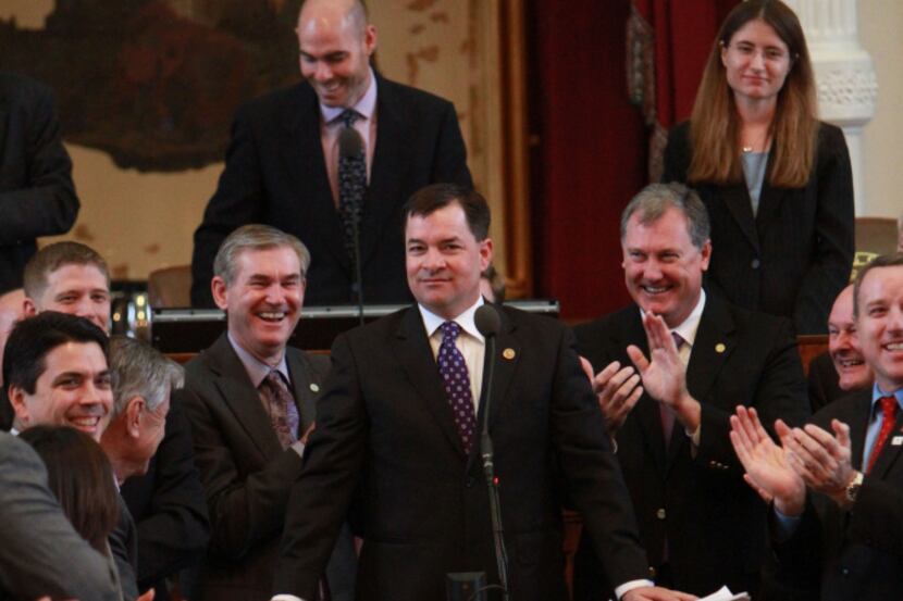 Democratic and Republican freshmen wearing purple surround fellow first-term Rep. Ken King,...