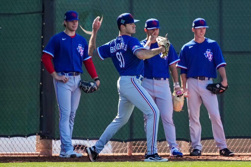 Pitcher Cody Bradford participates in a drill during a Texas Rangers minor league spring...