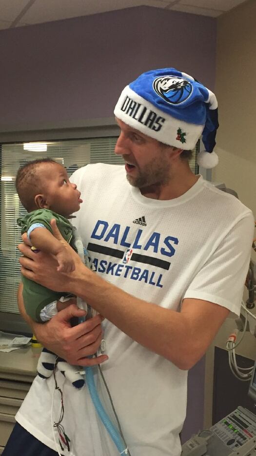 Dirk Nowitzki holds 8-month-old patient Ryan at Children's Medical Center