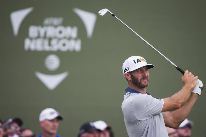 Dustin Johnson watches his shot from the 17th tee head for the water hazard during the final...