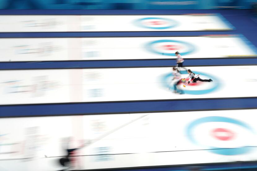 Kim Eun-jung of South Korea releases a stone in the women's curling gold medal match against...