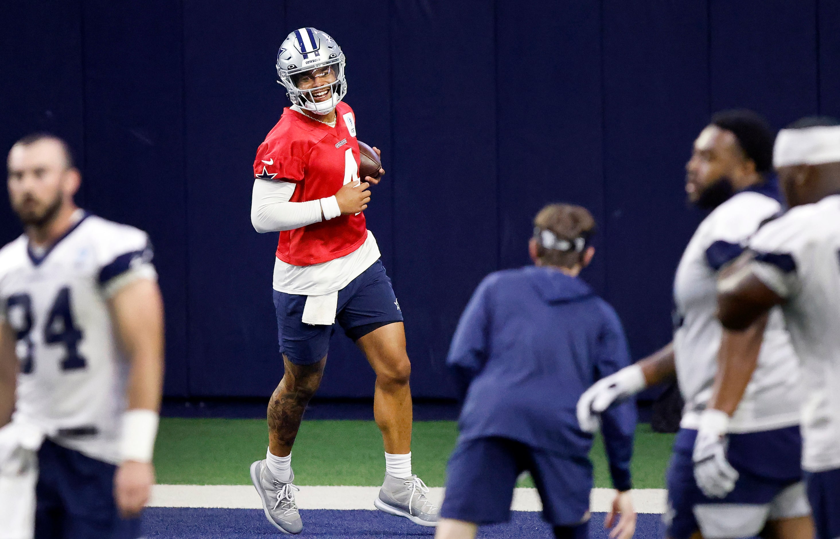 Dallas Cowboys quarterback Dak Prescott (4) smiles after he runs the ball into the end zone...