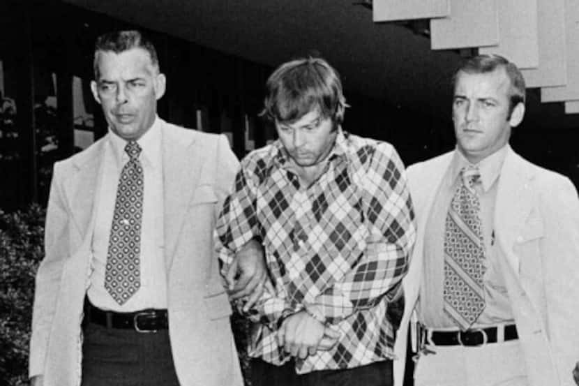 Edward C. Allaway (center) is escorted into the Orange County (Calif.) courthouse on July...