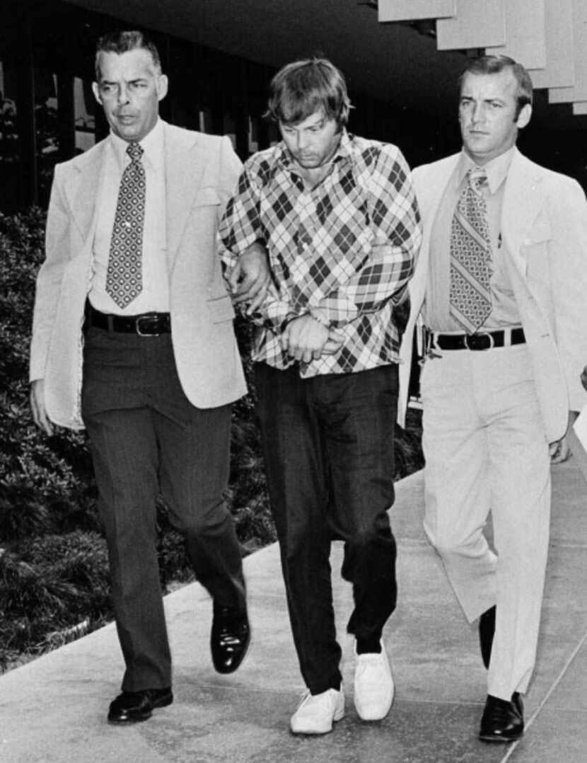 Edward C. Allaway (center) is escorted into the Orange County (Calif.) courthouse on July...