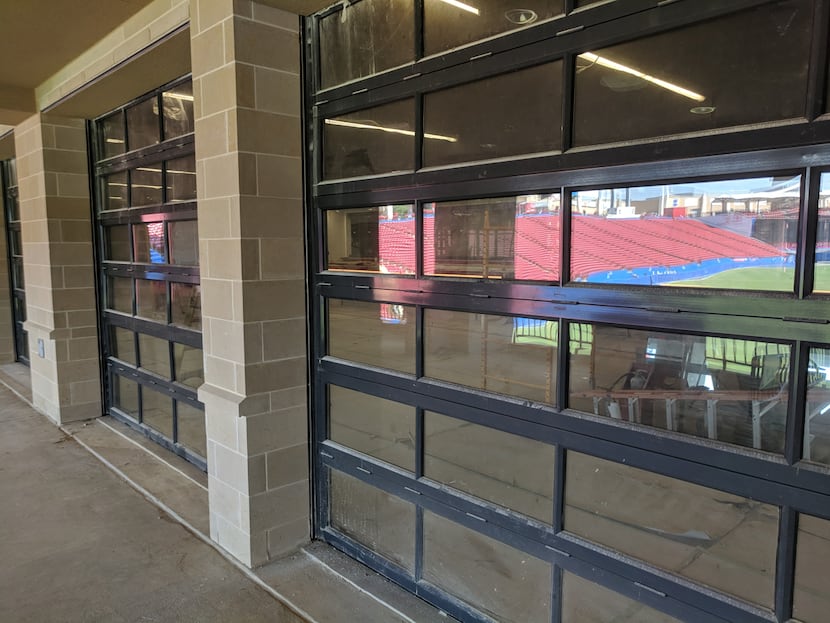 The garage style doors between the lower level seats and the club area.  